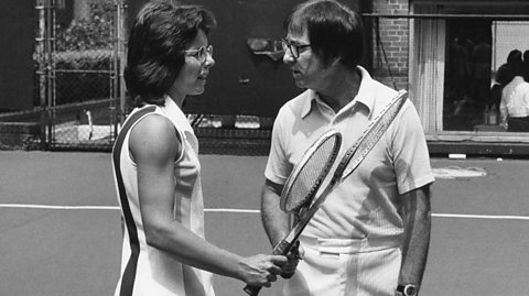Billie Jean King and Billy Riggs on the tennis court before the Battle of the Sexes match in 1973