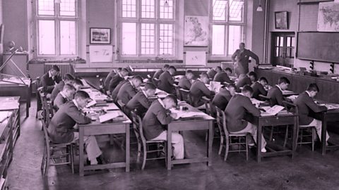 Children sat behind desks at school