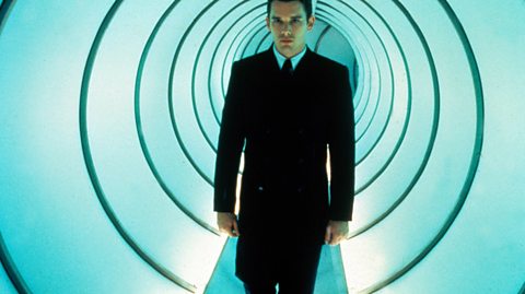 Actor Ethan Hawke walks in a brightly-lit tunnel in a still from the movie Gattaca.