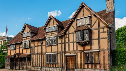 A photograph of Shakespeare's birthplace, a large, Tudor-style house.