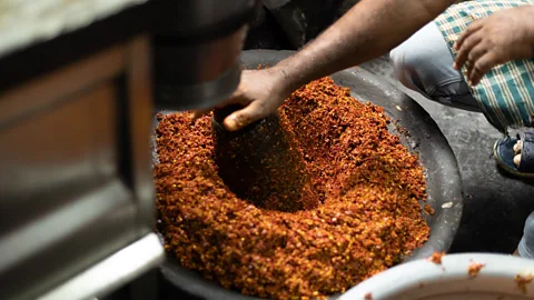 Hari Prasad Dried red chillies, chilli flakes, rock salt, fennel seeds and other spices are ground coarsely (Credit: Hari Prasad)