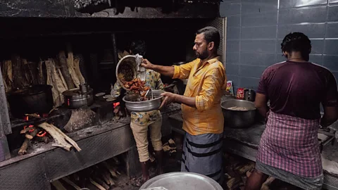 Hari Prasad The chicken pieces are marinated in a special masala and deep-fried in coconut oil on a wood-fired stove (Credit: Hari Prasad)