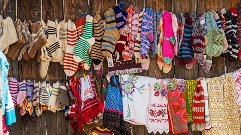 Hemis/Alamy Local women earn an income making socks, slippers and other handicrafts (Credit: Hemis/Alamy)