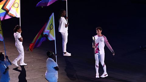 Tom Daley carries the Queen's Baton during the opening ceremony for the Commonwealth Games