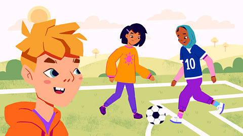 A boy looks at two girls playing football.