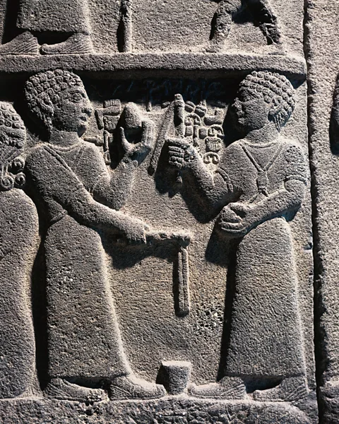 Getty Images A relief dating to the 9th Century BC in Turkey depicts two men playing with spinning tops (Credit: Getty Images)