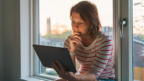 Getty A pensive woman looking at a screen