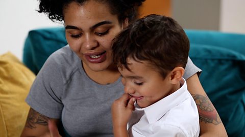 A mum reading to her son.