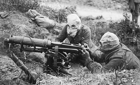 A British Vickers machine gun crew wearing gas masks near Ovillers during the Battle of the Somme, 1916.