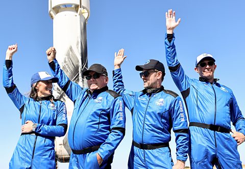 William Shatner and crewmates wave outside the Blue Origin sub-orbital capsule