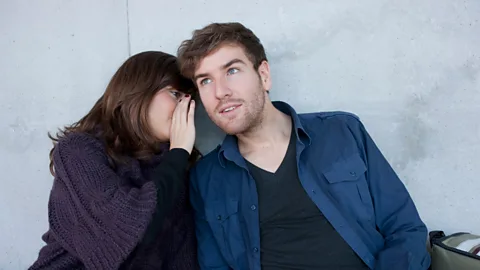 Getty A woman whispering to a man