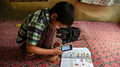 Idrees Abbas/Getty Images During the pandemic, mobile phones provided a crucial way for children to access online classes while at home (Credit: Idrees Abbas/Getty Images)