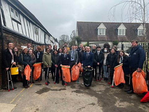 Students pose for a picture with their grabbers and rubbish bags