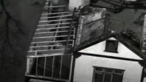 A black and white image of a flooded house, following the great storm of 1953.