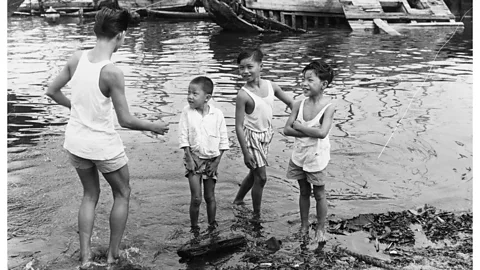 Getty Images Singaporean children play by the harbour in the early 1960s. As the country became wealthier, children began spending more and more time indoors (Credit: Getty Images)