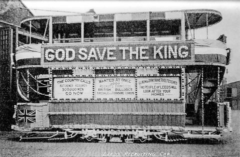 A tramcar decorated with recruitment advertisements aimed at encouraging volunteers for the war effort during World War One.