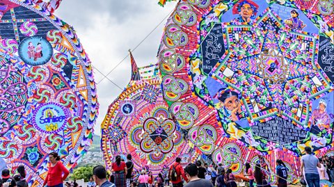 Crowds hold giant kites to honour the spirits of the dead in Guatemala.