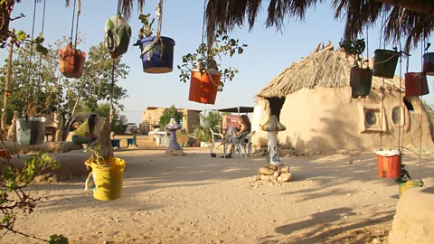 Israel Images/Alamy Visitors to Lotan stay in eco-friendly mud domes and help build structures from mud (Credit: Israel Images/Alamy)