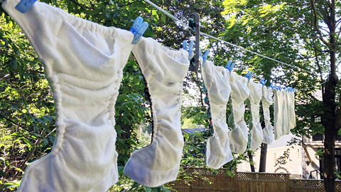 Reusable nappies hung on a washing line to dry.