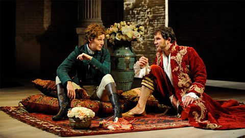 Orsino and Viola sit on the floor together in conversation
