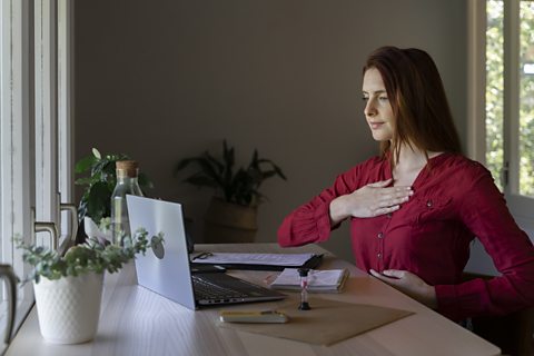 A woman uses breathing techniques