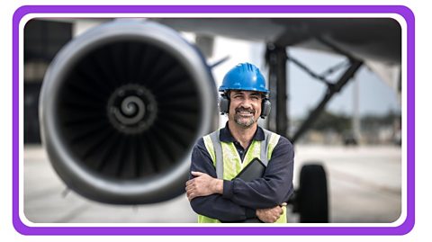 Airport worker wearing ear defenders.