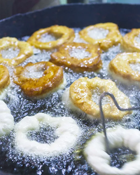 Chris Griffiths/Getty Images Dough is formed into a ring and dipped in frying oil for about a minute each side (Credit: Chris Griffiths/Getty Images)