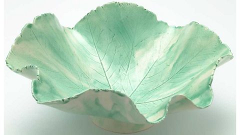 A green glazed bowl designed to resemble a leaf