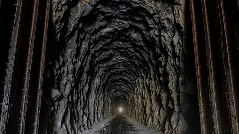 yhelfman/Getty Images It took Chinese workers more than two years to hand-chisel the 1,700ft-long tunnel at Donner Summit (Credit: yhelfman/Getty Images)