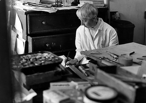 A black and white photo of Hannah Höch in her workshop surrounded by tools, in 1967.