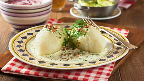 Simon Reddy/Alamy Cepelinai, or zeppelins, are large potato dumplings served with sour cream (Credit: Simon Reddy/Alamy)