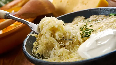 Zoonar GmbH/Alamy Kugelis is a dish of oven-baked grated potatoes mixed with onions, milk, eggs, salt, pepper and bacon (Credit: Zoonar GmbH/Alamy)