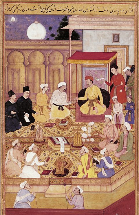 A painting of a group of men sat in a circle. Most are wearing colourful clothing, two are wearing all black. The Emperor sits at the top of the circle and holds his hand out to his guests.