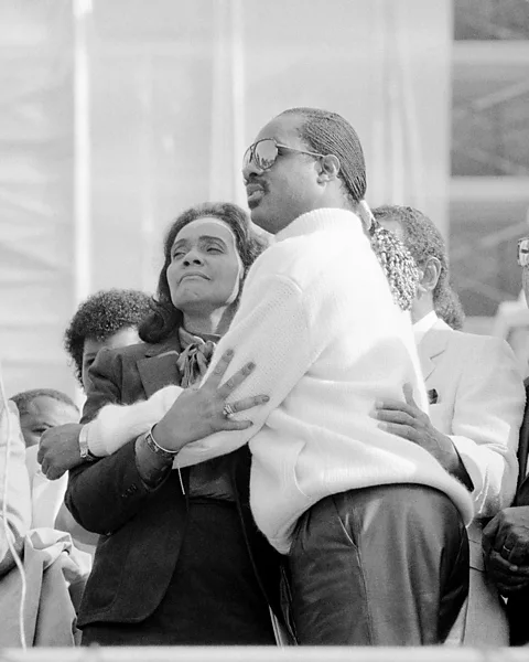 Getty Images Stevie Wonder and Coretta Scott King embrace after a campaign to make Martin Luther King Day a national holiday bears fruit (Credit: Getty Images)