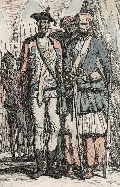 A coloured drawing of men dressed in a mix of British army uniforms and traditional Indian dress, some wearing turbans, carrying swords, sabres and spears standing in neat rows.