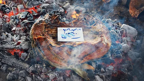 Simon Urwin Iraq's national dish of masgouf is often cooked over a fire to crisp the carp skin (Credit: Simon Urwin)