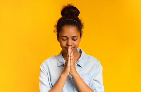 A girl in prayer.