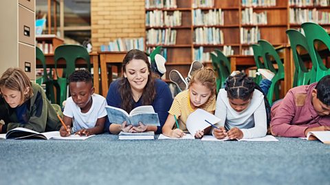 Teachers reading with pupils