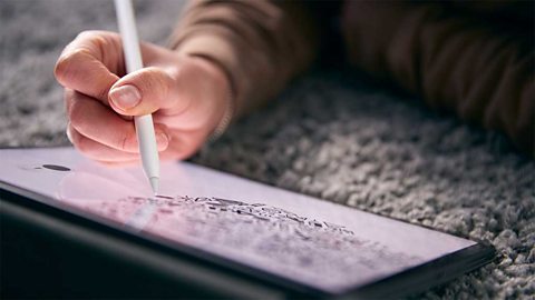 Closeup of a hand drawing a pattern on a tablet