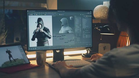 View over the shoulder of someone designing a character on a desktop computer