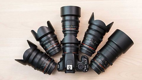 A camera and 6 different camera lenses