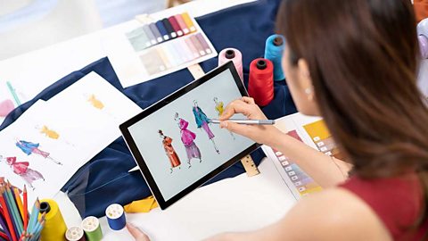 Fashion designs being drawn on a tablet