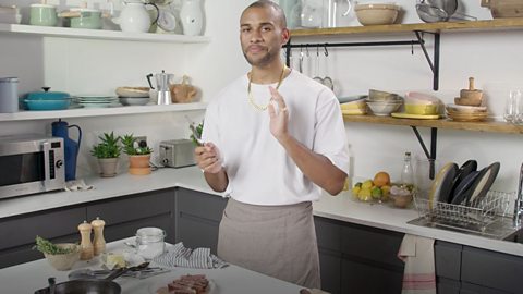 Joseph Denison Carey with a steak he has just cooked