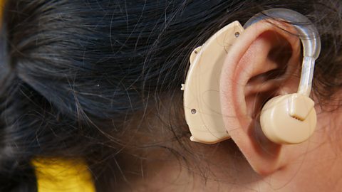 A child wearing a hearing aid.