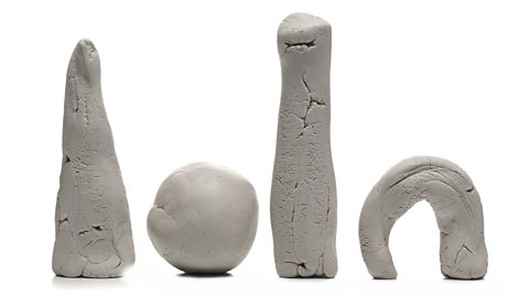 Four pieces of clay moulded into different shapes. 