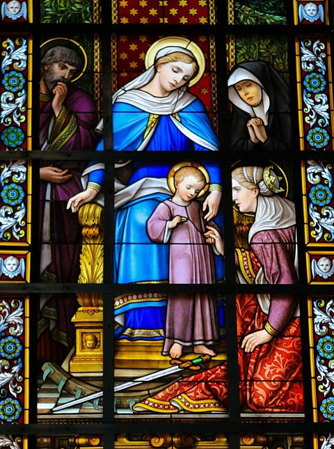 A stained glass depiction of Mary and Jesus.