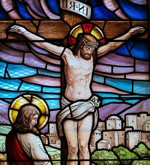 The crucifixion of Jesus depicted in stained glass.