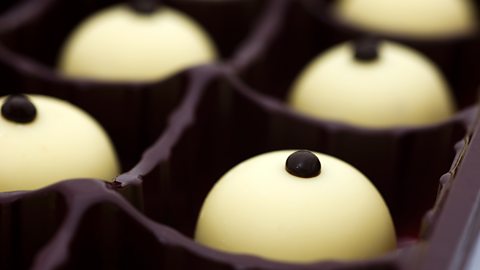 Other reasons why chocolate is so enjoyable A box of round chocolates with each with a little chocolate mound on top