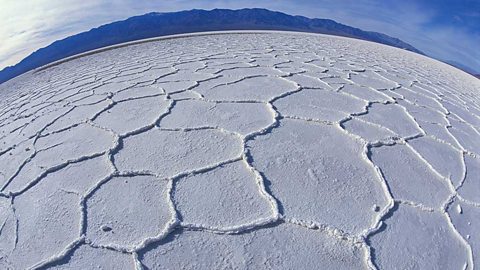 A deserted white salt flat as seen through a wide-angle lens