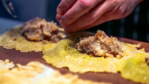 Alicia Erickson Yurii Kovryzhenko fills cabbage leaves with about a tablespoon of the stuffing (Credit: Alicia Erickson)